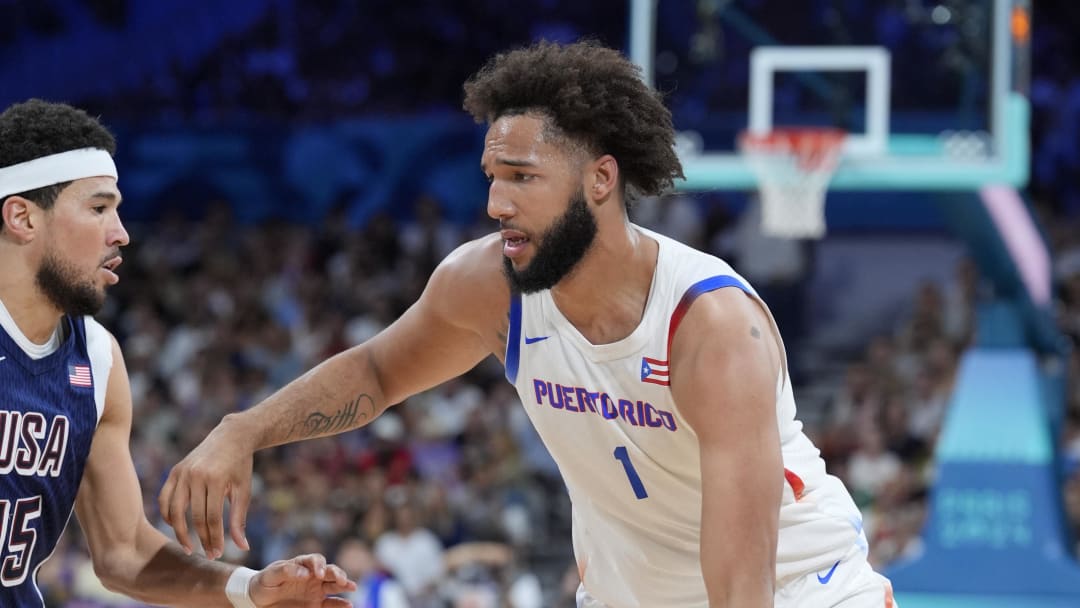 Aug 3, 2024; Villeneuve-d'Ascq, France; Puerto Rico forward George Conditt IV (1) dribbles against United States guard Devin Booker (15) in the third quarter against Puerto Rico during the Paris 2024 Olympic Summer Games at Stade Pierre-Mauroy. Mandatory Credit: John David Mercer-USA TODAY Sports