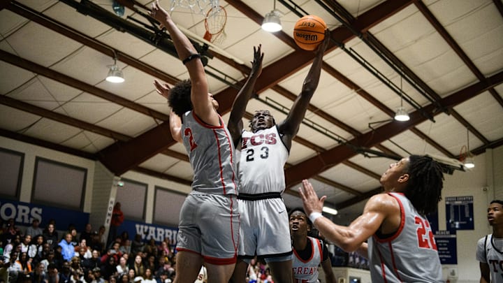 Trinity Christian’s Baganley Donzo attempts to put up a shot while being covered by Berean Baptist’s Justin Caldwell during the second quarter on Friday, Feb. 7, 2025, at Fayetteville Christian School.