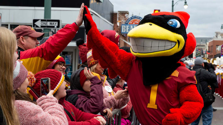 Iowa State mascot Cy the Cardinal high fives fans during the Beale Street Parade for Iowa State University and University of Memphis in Downtown Memphis, Tenn., on Thursday, December 28, 2023. Iowa State will play Memphis in the AutoZone Liberty Bowl on Friday.