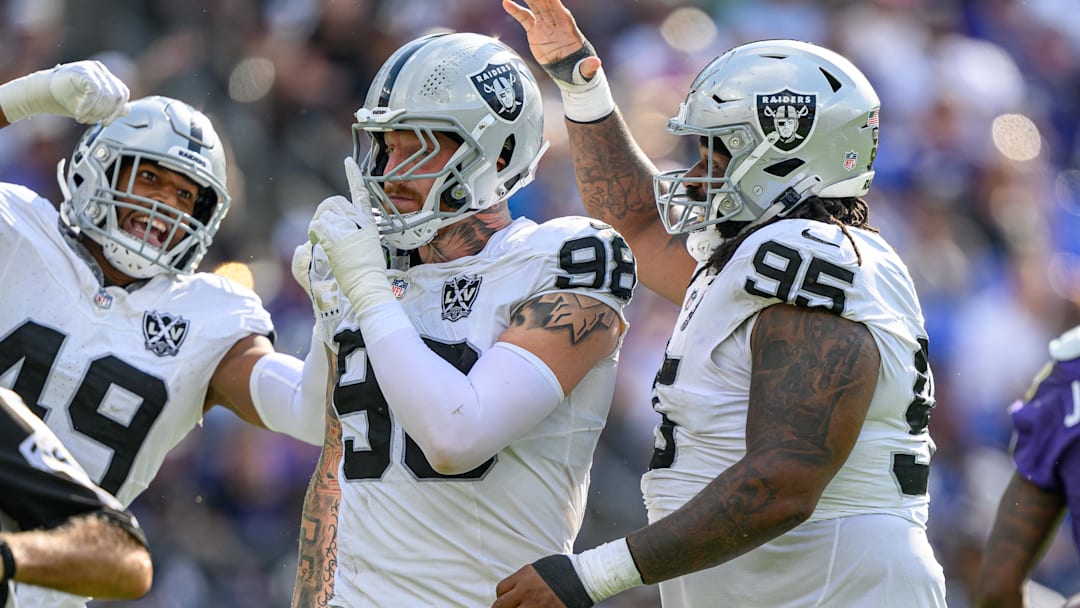 Sep 15, 2024; Baltimore, Maryland, USA; Las Vegas Raiders defensive end Maxx Crosby (98) celebrates with defensive end Charles Snowden (49) and defensive tackle John Jenkins (95) after sacking Baltimore Ravens quarterback Lamar Jackson (not pictured) during the second half at M&T Bank Stadium. Mandatory Credit: Reggie Hildred-Imagn Images