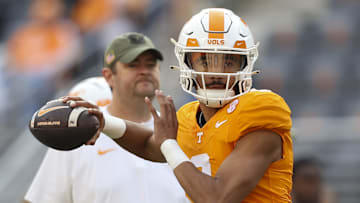 Nov 25, 2023; Knoxville, Tennessee, USA; Tennessee Volunteers quarterback Nico Iamaleava (8) warms up as head coach Josh Heupel looks on before the game against the Vanderbilt Commodores at Neyland Stadium. Mandatory Credit: Randy Sartin-Imagn Images