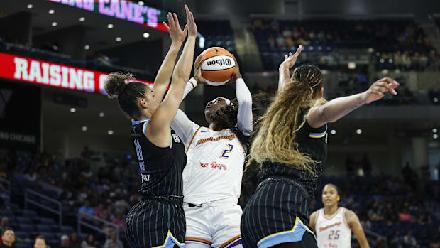 A photo of Kahleah Copper going to the basket and drawing a foul