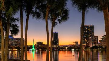 Palm trees at sunset in Lake Eola Park in Orlando, Florida, a top-ranked staycation city.