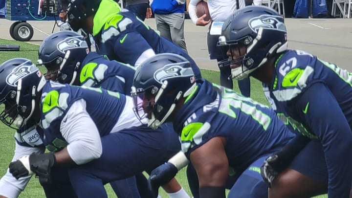 The Seahawks offensive line prepares for a run-fit walkthrough drill. From left to right, McClendon Curtis, Olu Oluwatimi, Laken Tomlinson, and Charles Cross.