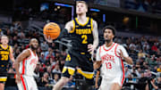 Mar 12, 2025; Indianapolis, IN, USA; Iowa Hawkeyes guard Brock Harding (2) shoots the ball while Ohio State Buckeyes forward Sean Stewart (13) defends in the first half  at Gainbridge Fieldhouse. Mandatory Credit: Trevor Ruszkowski-Imagn Images