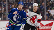 Mar 15, 2022; Vancouver, British Columbia, CAN; Vancouver Canucks defenseman Quinn Hughes (43) shares laugh with his brother New Jersey Devils forward Jack Hughes (86) in the second period at Rogers Arena. Mandatory Credit: Bob Frid-USA TODAY Sports