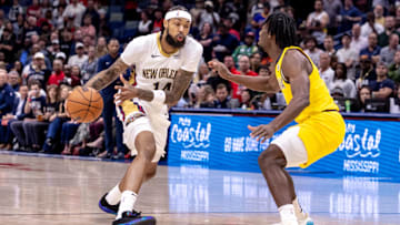 Nov 1, 2024; New Orleans, Louisiana, USA;  New Orleans Pelicans forward Brandon Ingram (14) dribbles against Indiana Pacers forward Aaron Nesmith (23) during the first half at Smoothie King Center. Mandatory Credit: Stephen Lew-Imagn Images