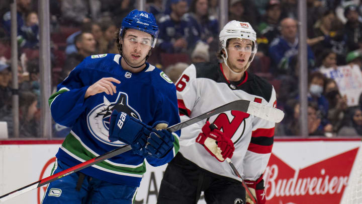 Mar 15, 2022; Vancouver, British Columbia, CAN; Vancouver Canucks defenseman Quinn Hughes (43) shares laugh with his brother New Jersey Devils forward Jack Hughes (86) in the second period at Rogers Arena. Mandatory Credit: Bob Frid-USA TODAY Sports