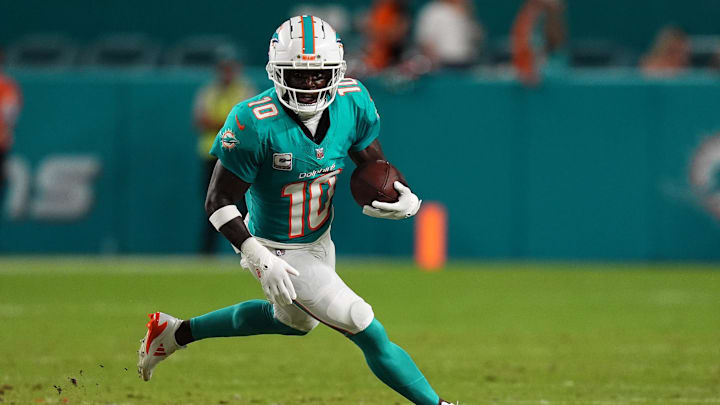 Sep 30, 2024; Miami Gardens, Florida, USA; Miami Dolphins wide receiver Tyreek Hill (10) runs with the ball during the first half against the Tennessee Titans at Hard Rock Stadium. Mandatory Credit: Jasen Vinlove-Imagn Images