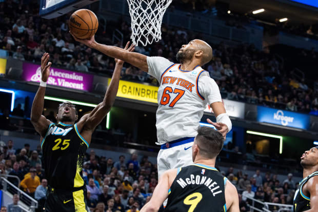Dec 30, 2023; Indianapolis, Indiana, USA; New York Knicks forward Taj Gibson (67) rebounds the ball while Indiana Pacers forward Jalen Smith (25) defends in the second half at Gainbridge Fieldhouse. Mandatory Credit: Trevor Ruszkowski-USA TODAY Sports
