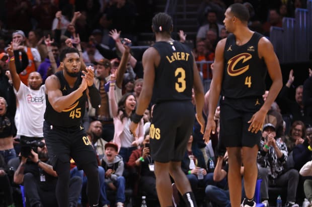 Donovan Mitchell (45) reacts with teammates guard Caris LeVert (3) and center Evan Mobley (4).