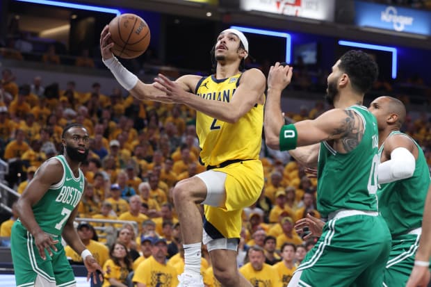 Indiana Pacers guard Andrew Nembhard shoots the ball against Boston Celtics guard Jaylen Brown and forward Jayson Tatum.