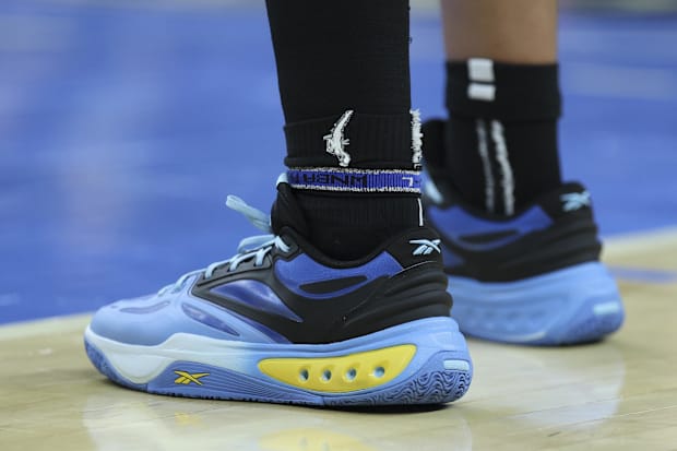 Angel Reese's blue and black Reebok sneakers.