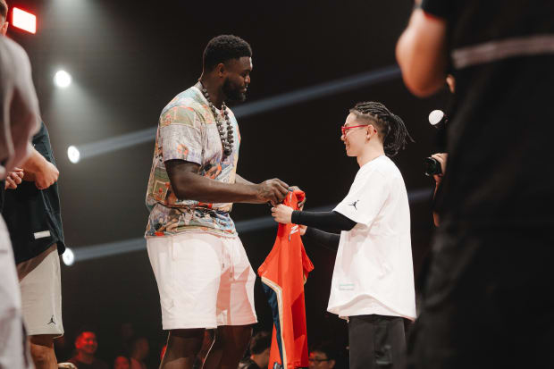 Zion Williamson gives his jersey to a fan.