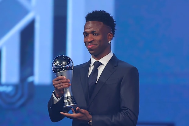 Real Madrid forward Vinicius holds his FIFA The Best award