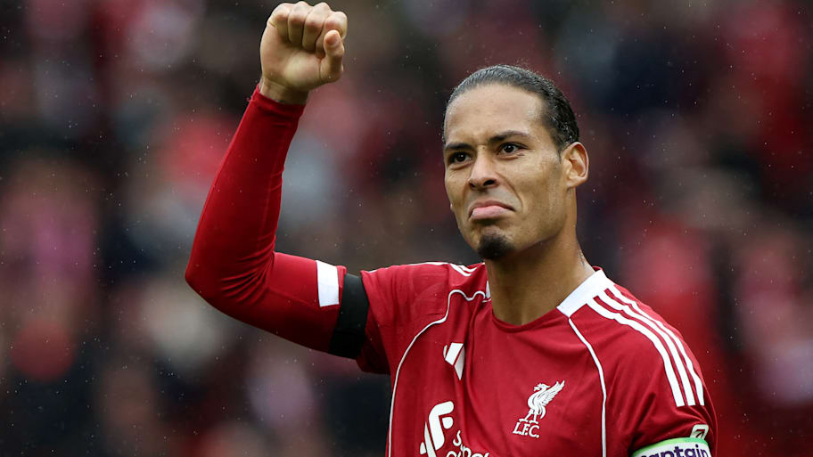 Virgil van Dijk with an arm raised aloft.