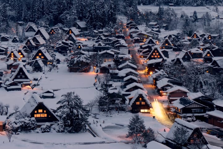 overhead view of Shirakawa-go in winter, covered in snow, at dusk