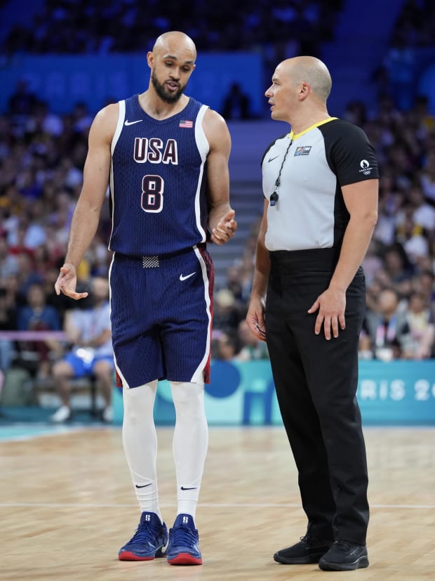 Team USA forward Derrick White talks to an official during the Olympics.