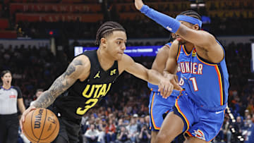 Mar 20, 2024; Oklahoma City, Oklahoma, USA; Utah Jazz guard Keyonte George (3) moves the ball around Oklahoma City Thunder guard Aaron Wiggins (21) during the second half at Paycom Center. Mandatory Credit: Alonzo Adams-Imagn Images