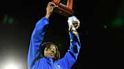 Miami Northwestern's Teddy Bridgewater raises the state trophy following the team's win over Raines in the Class 3A championship on Dec. 14, 2024.