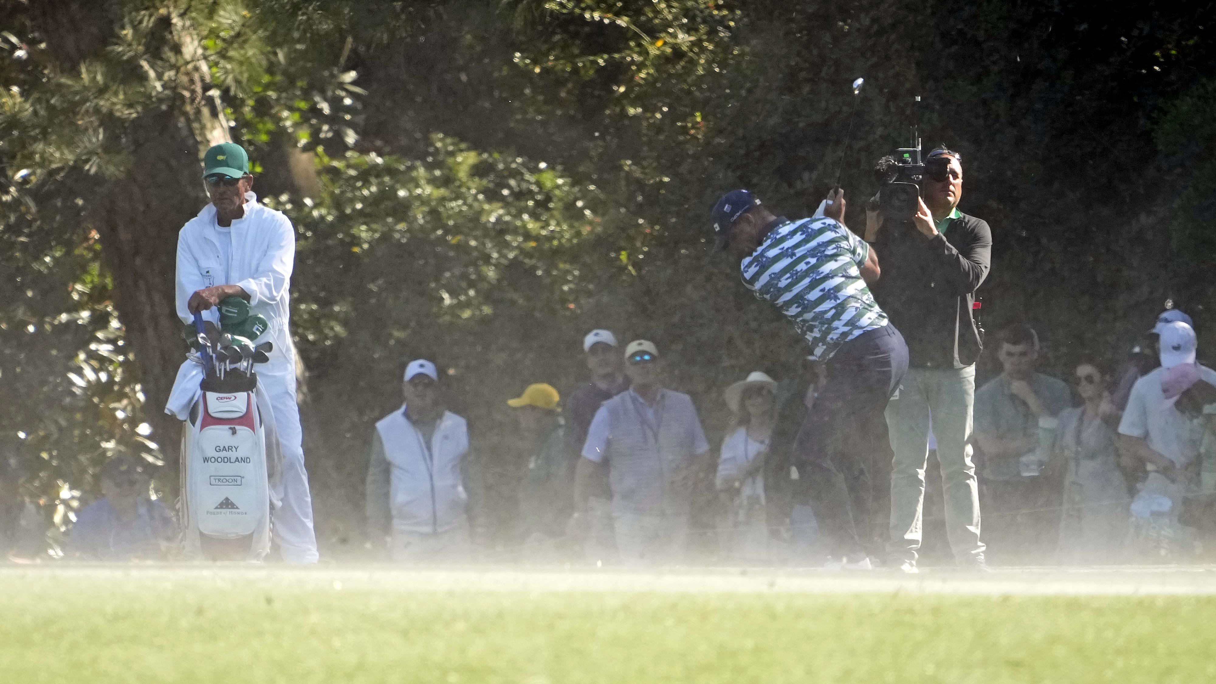 Gary Woodland hits as wind swirls sand around Augusta National at the Masters. 