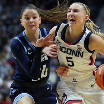 Mar 9, 2025; Uncasville, CT, USA; UConn Huskies guard Paige Bueckers (5) drives the ball against Villanova Wildcats guard Dani Ceseretti (24) in the first half at Mohegan Sun Arena. Mandatory Credit: David Butler II-Imagn Images