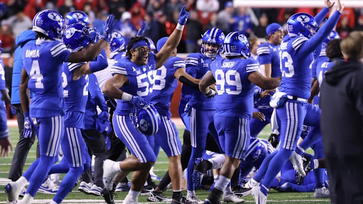 Nov 9, 2024; Salt Lake City, Utah, USA; The Brigham Young Cougars run on the field after defeating the Utah Utes at Rice-Eccles Stadium. Mandatory Credit: Rob Gray-Imagn Images