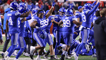Nov 9, 2024; Salt Lake City, Utah, USA; The Brigham Young Cougars run on the field after defeating the Utah Utes at Rice-Eccles Stadium. Mandatory Credit: Rob Gray-Imagn Images