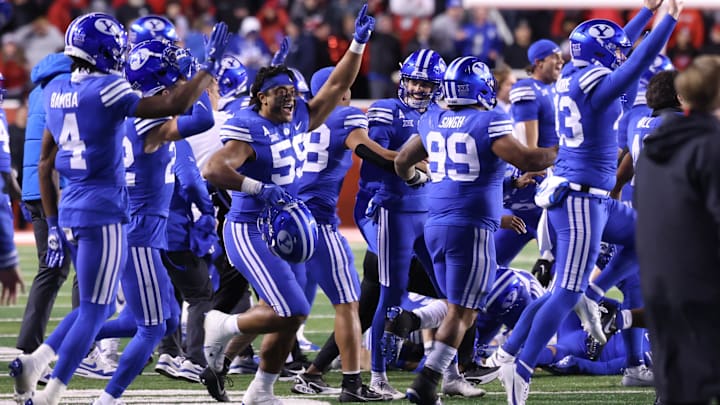 Nov 9, 2024; Salt Lake City, Utah, USA; The Brigham Young Cougars run on the field after defeating the Utah Utes at Rice-Eccles Stadium. Mandatory Credit: Rob Gray-Imagn Images