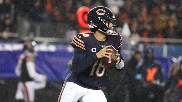 Chicago Bears quarterback Caleb Williams (18) rolls out of the pocket