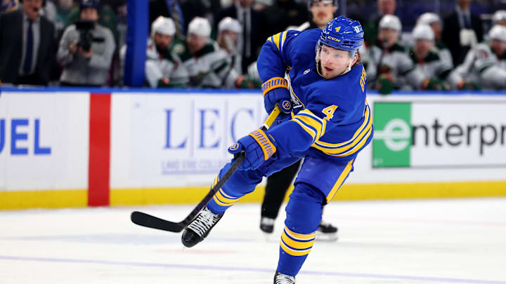 Nov 27, 2024; Buffalo, New York, USA;  Buffalo Sabres defenseman Bowen Byram (4) takes a shot on goal during the second period against the Minnesota Wild at KeyBank Center. Mandatory Credit: Timothy T. Ludwig-Imagn Images