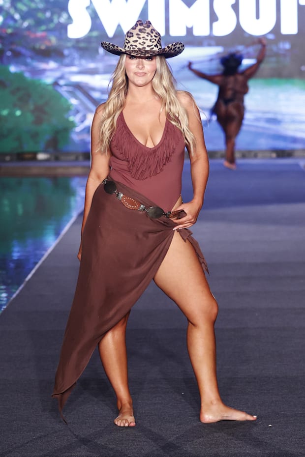 Camille Kostek. Swimsuit by LSPACE. Hat by Zandria. Sarong by Myra Swim. Belt by Streets Ahead. 