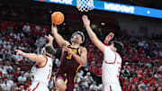 Mar 1, 2025; Lincoln, Nebraska, USA; Minnesota Golden Gophers forward Dawson Garcia (3) drives against Nebraska Cornhuskers guard Sam Hoiberg (1) and forward Berke Buyuktuncel (9) during the second half at Pinnacle Bank Arena. Mandatory Credit: Steven Branscombe-Imagn Images