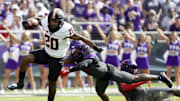 Oct 15, 2022; Fort Worth, Texas, USA; Oklahoma State Cowboys running back Dominic Richardson (20) runs past  TCU Horned Frogs safety Abraham Camara (14) during the first half at Amon G. Carter Stadium. Mandatory Credit: Raymond Carlin III-Imagn Images