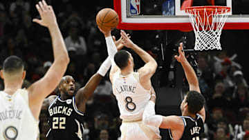 Dec 28, 2024; Chicago, Illinois, USA;   Chicago Bulls guard Zach LaVine (8) shoots against Milwaukee Bucks forward Khris Middleton (22)