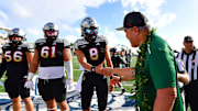  NFL retiree Jesse Sapolu shock hands with Team Mauka quarterback.  Mandatory Credit: Steven Erler-USA TODAY NETWORK  