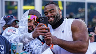 New York Jets defensive end Solomon Thomas takes a selfie with a fan before a game against the New England Patriots.