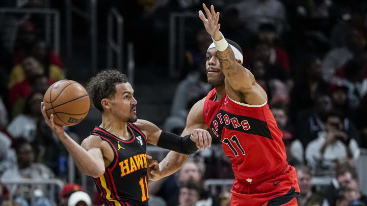 Feb 23, 2024; Atlanta, Georgia, USA; Atlanta Hawks guard Trae Young (11) tries to pass against Toronto Raptors forward Bruce Brown (11) during the second half at State Farm Arena. Mandatory Credit: Dale Zanine-USA TODAY Sports