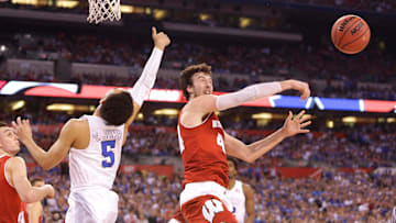 Wisconsin Badgers forward Frank Kaminsky slaps away a shot from Duke Blue Devils guard Tyus Jones during the NCAA Men's Basketball Championship game between Wisconsin and Duke at Lucas Oil Stadium in Indianapolis, Indiana, Monday, April 6, 2015.