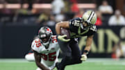 Oct 26, 2025; New Orleans, Louisiana, USA: New Orleans Saints wide receiver Chris Olave (12) is tackled by Tampa Bay Buccaneers cornerback Jamel Dean (35) during the fourth quarter at Caesars Superdome. Mandatory Credit: Stephen Lew-Imagn Images