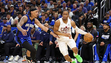 Apr 27, 2024; Orlando, Florida, USA; Cleveland Cavaliers forward Isaac Okoro (35) moves the ball past Orlando Magic forward Paolo Banchero (5) in the fourth quarter during game four of the first round for the 2024 NBA playoffs at Kia Center. Mandatory Credit: Nathan Ray Seebeck-Imagn Images