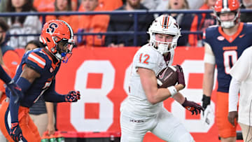 Nov 2, 2024; Syracuse, New York, USA; Virginia Tech Hokies wide receiver Stephen Gosnell (12) runs past Syracuse Orange defensive back Marcellus Barnes Jr. (7) after making a catch in the first quarter at JMA Wireless Dome. Mandatory Credit: Mark Konezny-Imagn Images
