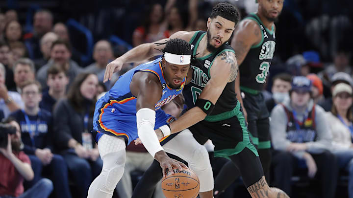 Jan 3, 2023; Oklahoma City, Oklahoma, USA; Oklahoma City Thunder guard Luguentz Dort (5) works to keep the ball away from Boston Celtics forward Jayson Tatum (0) during the first quarter at Paycom Center. Mandatory Credit: Alonzo Adams-Imagn Images