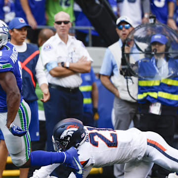 Sep 8, 2024; Seattle, Washington, USA; Seattle Seahawks running back Kenneth Walker III (9) breaks a tackle attempt by Denver Broncos cornerback Riley Moss (21) to rush for a touchdown during the third quarter at Lumen Field. Mandatory Credit: Joe Nicholson-Imagn Images