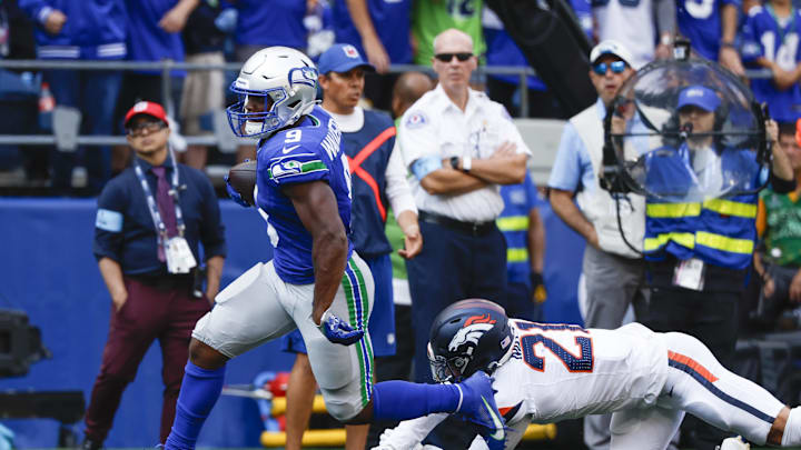 Sep 8, 2024; Seattle, Washington, USA; Seattle Seahawks running back Kenneth Walker III (9) breaks a tackle attempt by Denver Broncos cornerback Riley Moss (21) to rush for a touchdown during the third quarter at Lumen Field. Mandatory Credit: Joe Nicholson-Imagn Images