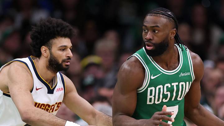 Mar 2, 2025; Boston, Massachusetts, USA; Boston Celtics forward Jaylen Brown (7) dribbles down the court defended by Denver Nuggets guard Jamal Murray (27) during the first half at TD Garden. Mandatory Credit: Paul Rutherford-Imagn Images