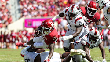 Sep 2, 2023; Norman, Oklahoma, USA; Oklahoma Sooners running back Jovantae Barnes (2) leaps for yardage past Arkansas State Red Wolves defensive end Keyron Crawford (25) during the first quarter at Gaylord Family-Oklahoma Memorial Stadium. Mandatory Credit: Kevin Jairaj-Imagn Images