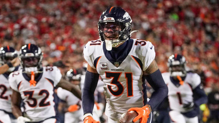 Oct 12, 2023; Kansas City, Missouri, USA; Denver Broncos safety Justin Simmons (31) celebrates after making an interception against the Kansas City Chiefs during the first half at GEHA Field at Arrowhead Stadium. Mandatory Credit: Denny Medley-USA TODAY Sports