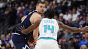 Feb 20, 2025; Denver, Colorado, USA; Charlotte Hornets forward Moussa Diabate (14) defends on Denver Nuggets center Nikola Jokic (15) in the second half at Ball Arena. Mandatory Credit: Ron Chenoy-Imagn Images