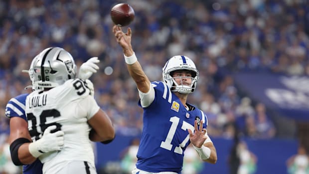 Colts quarterback Daniel Jones (Blue and White Uniform) passes the ball against the Las Vegas Raiders.